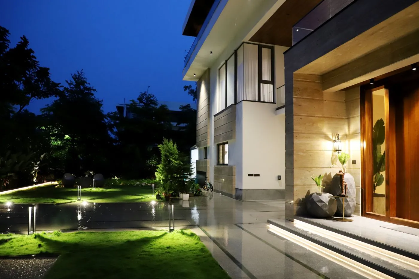 A finished architect-grade custom home lit at dusk