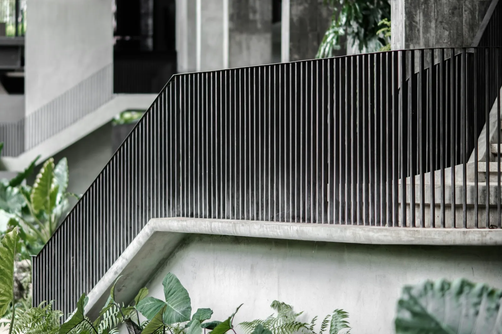 Dark steel boundary fence run along a property