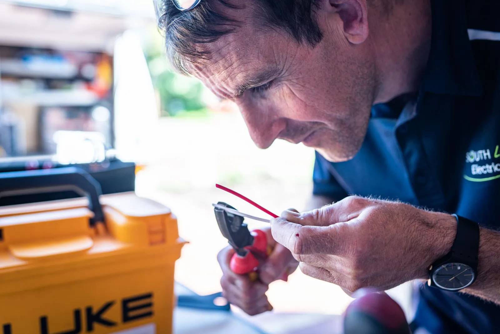 A licensed Brightside electrician carefully working on wiring at a Perth home