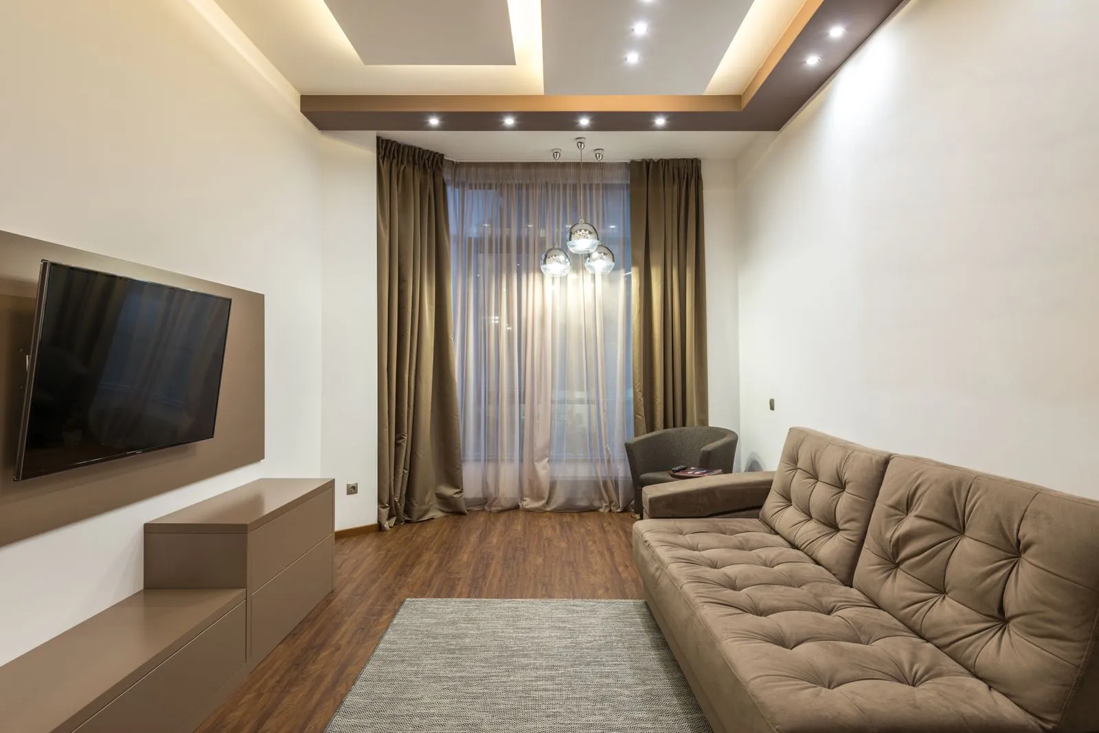Living room with neat new LED downlights installed across the ceiling