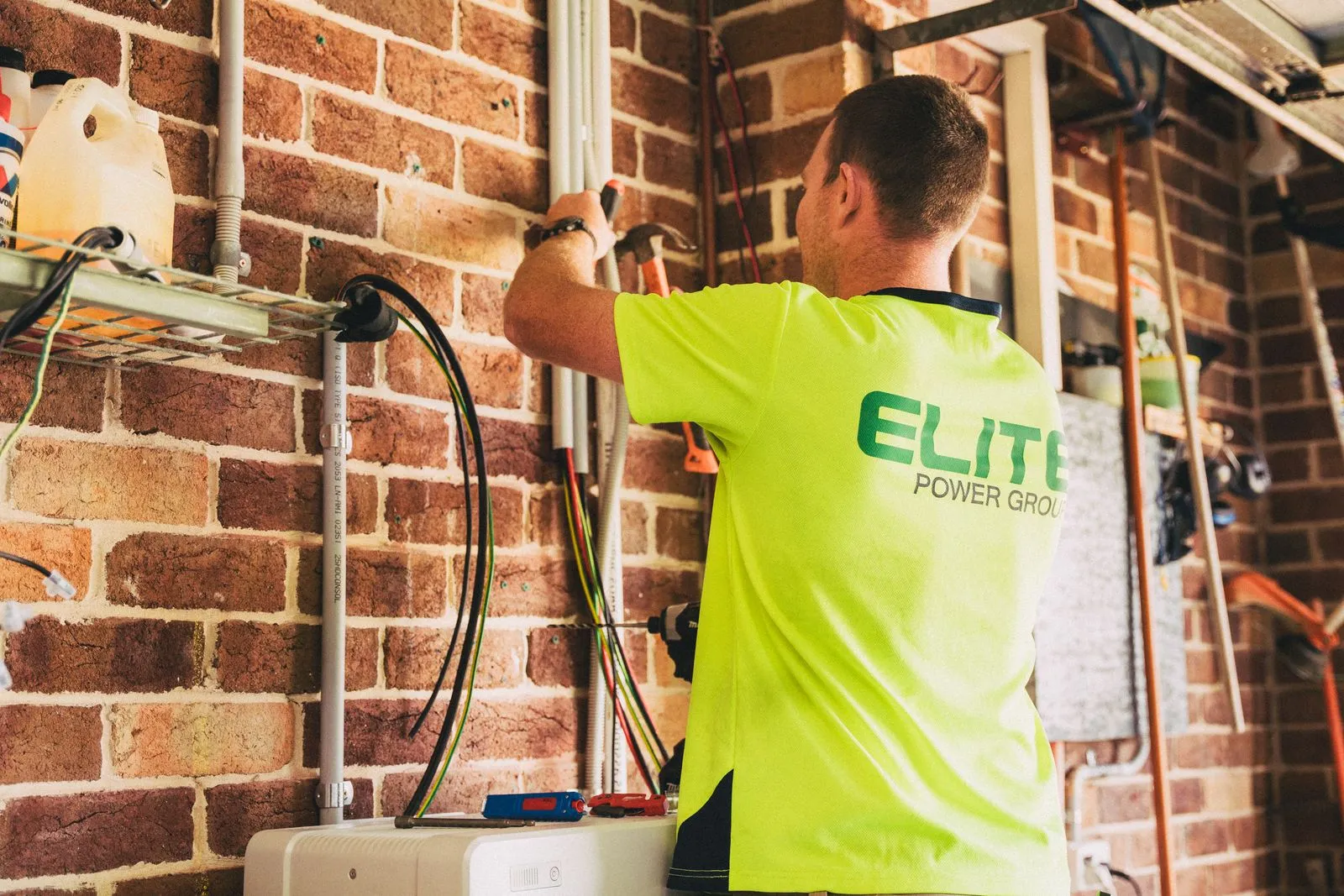 A licensed electrician running tidy new wiring on a fault-find and rewire job