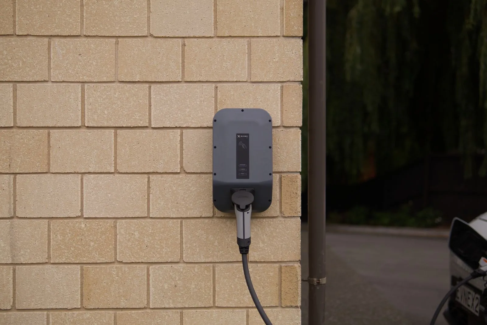 A home electric vehicle charger neatly installed on a garage wall