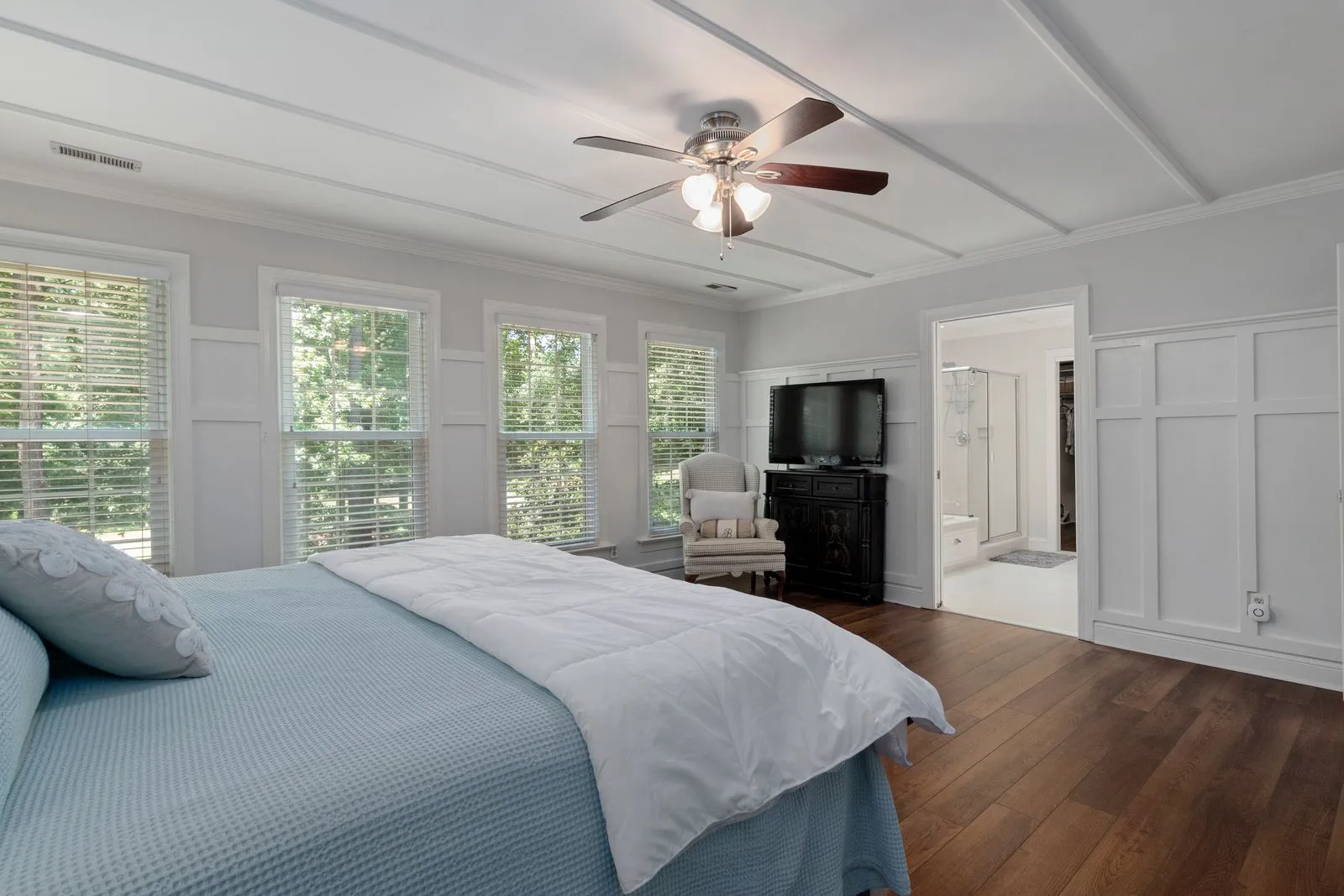 A quiet ceiling fan installed in a bright bedroom