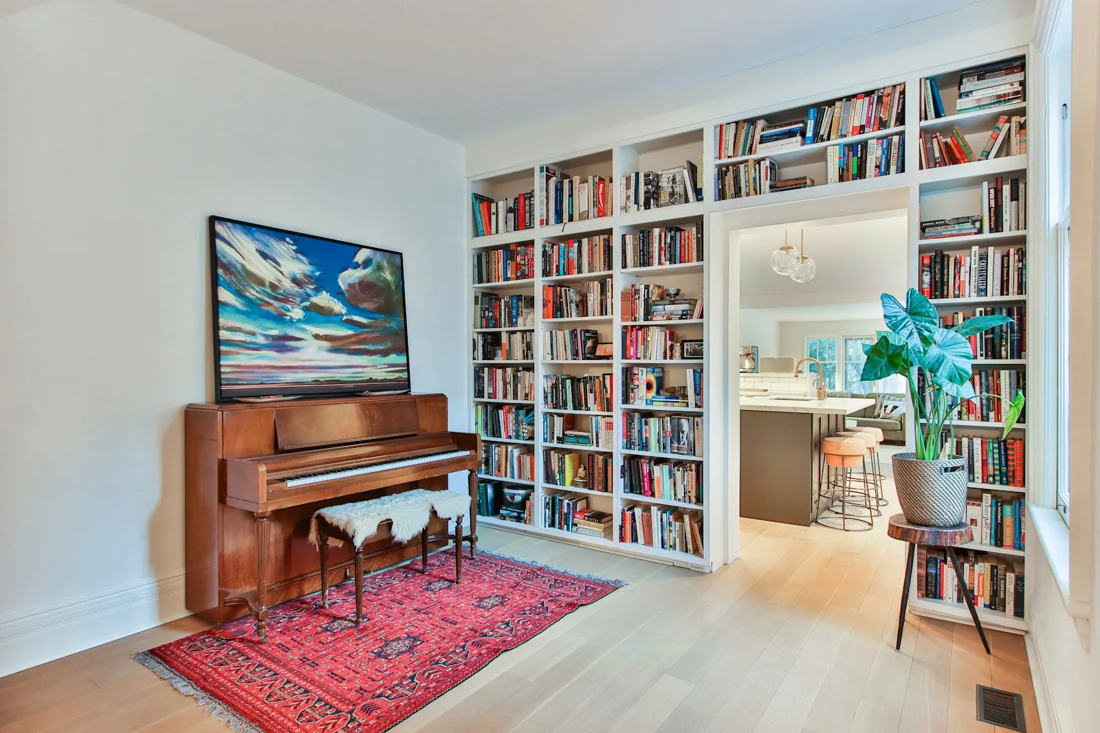Built-in timber bookshelf wall surrounding a doorway