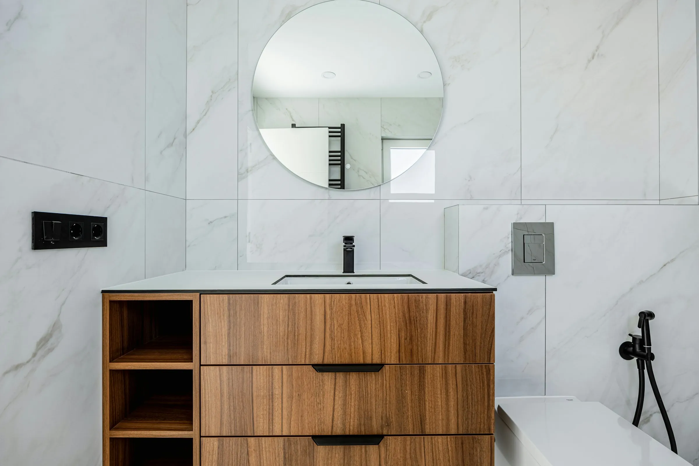 Clean modern bathroom with chrome plumbing fixtures installed by PureFlow