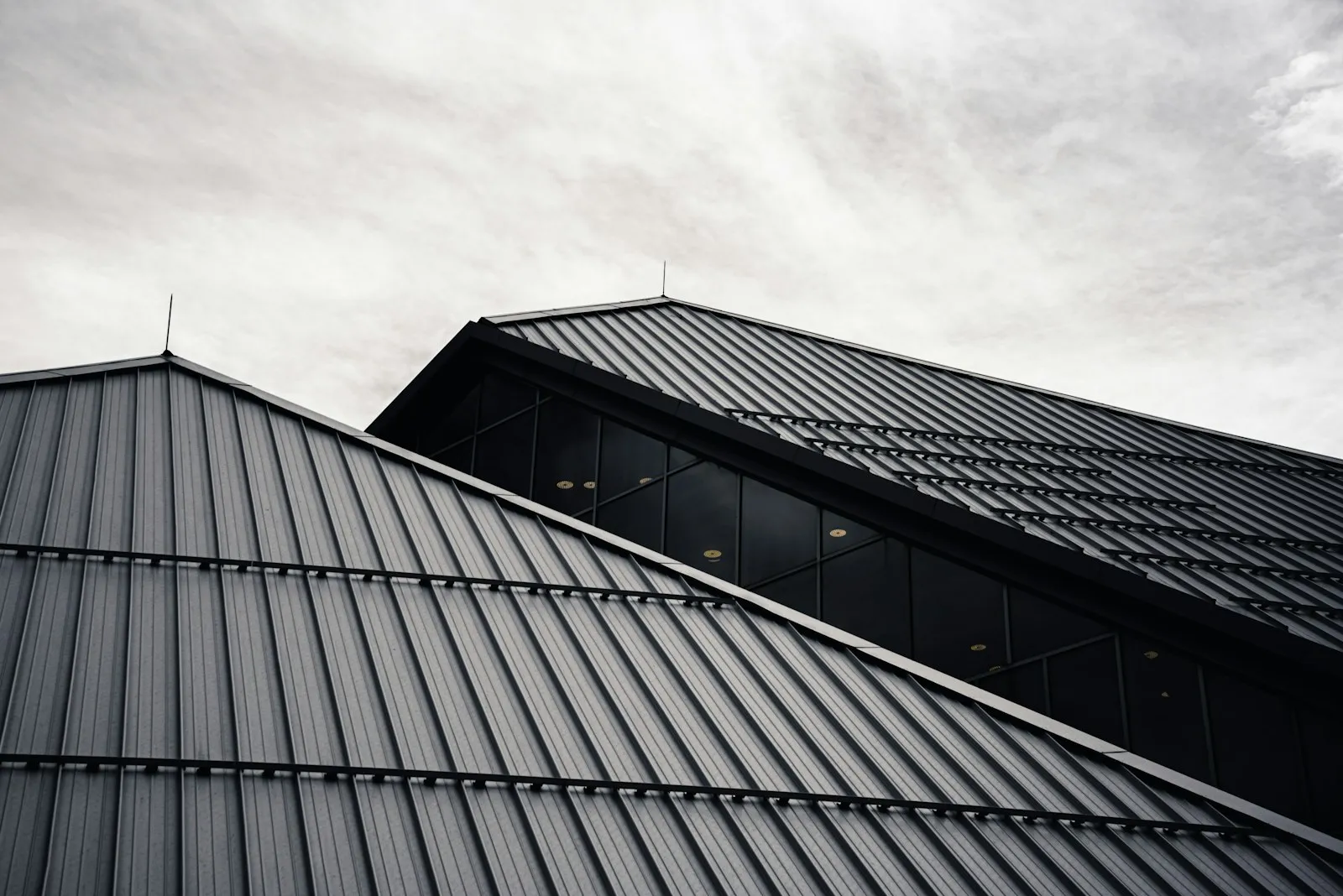 New charcoal Colorbond metal roof on a Perth home against a blue sky