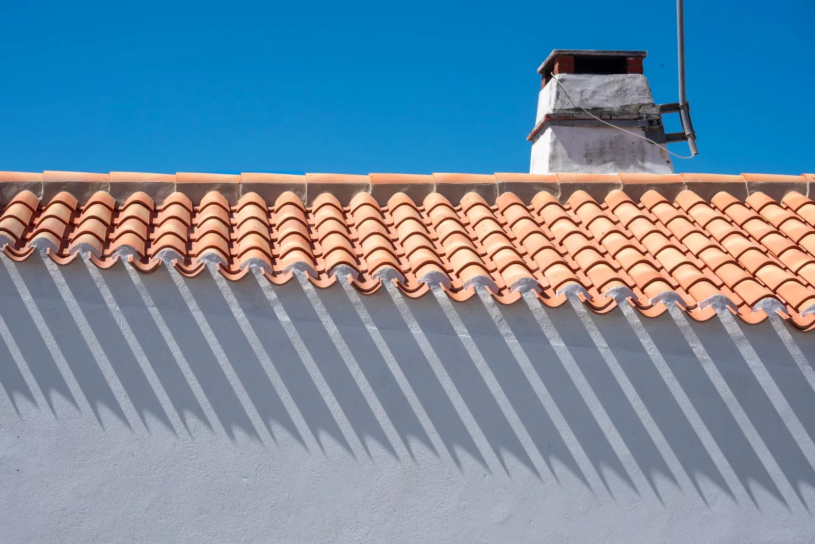 Restored and re-coated terracotta tile roof