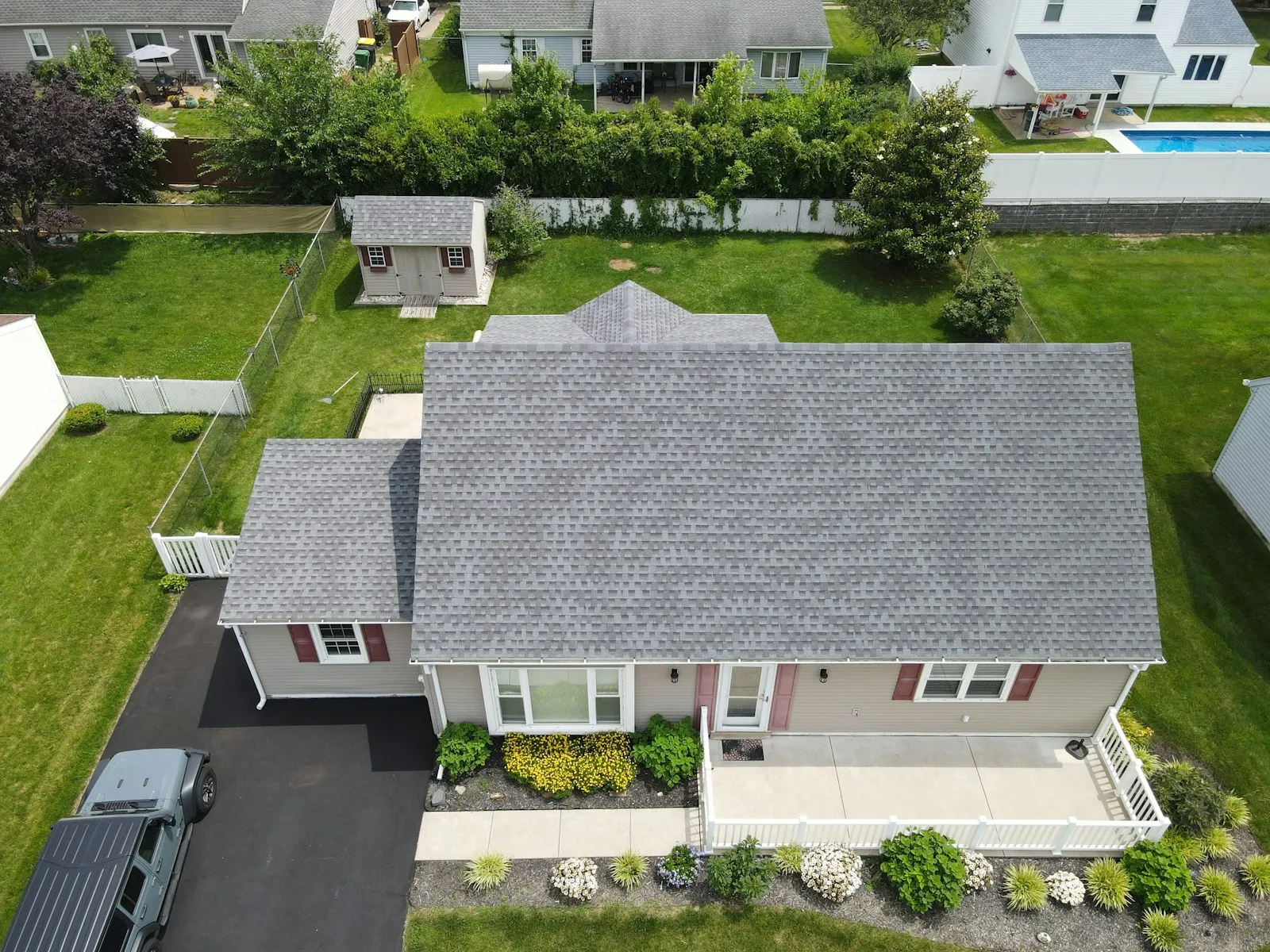 Wide view of a freshly laid metal roof with clean ridge line under a clear sky