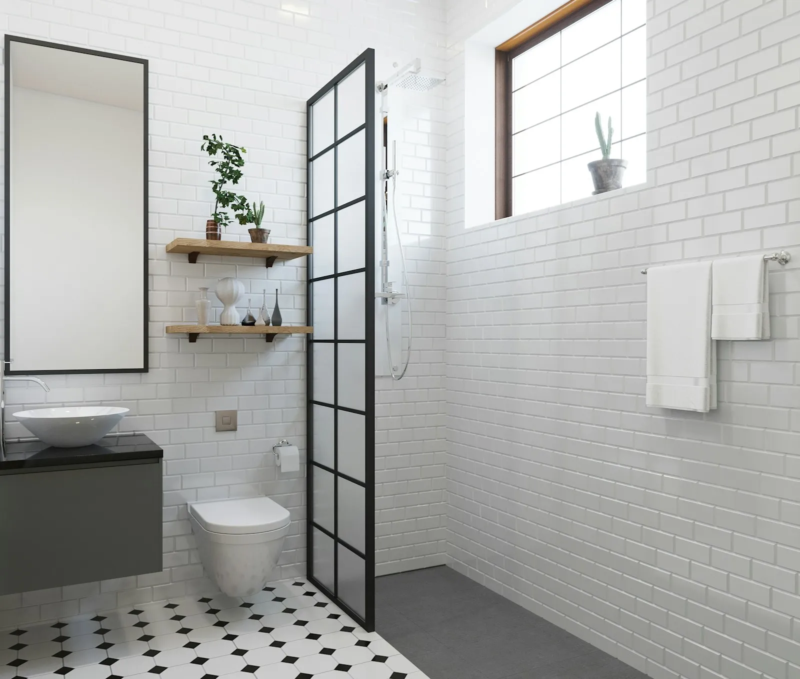 A tiled ensuite with a black framed shower screen and warm lighting in Claremont